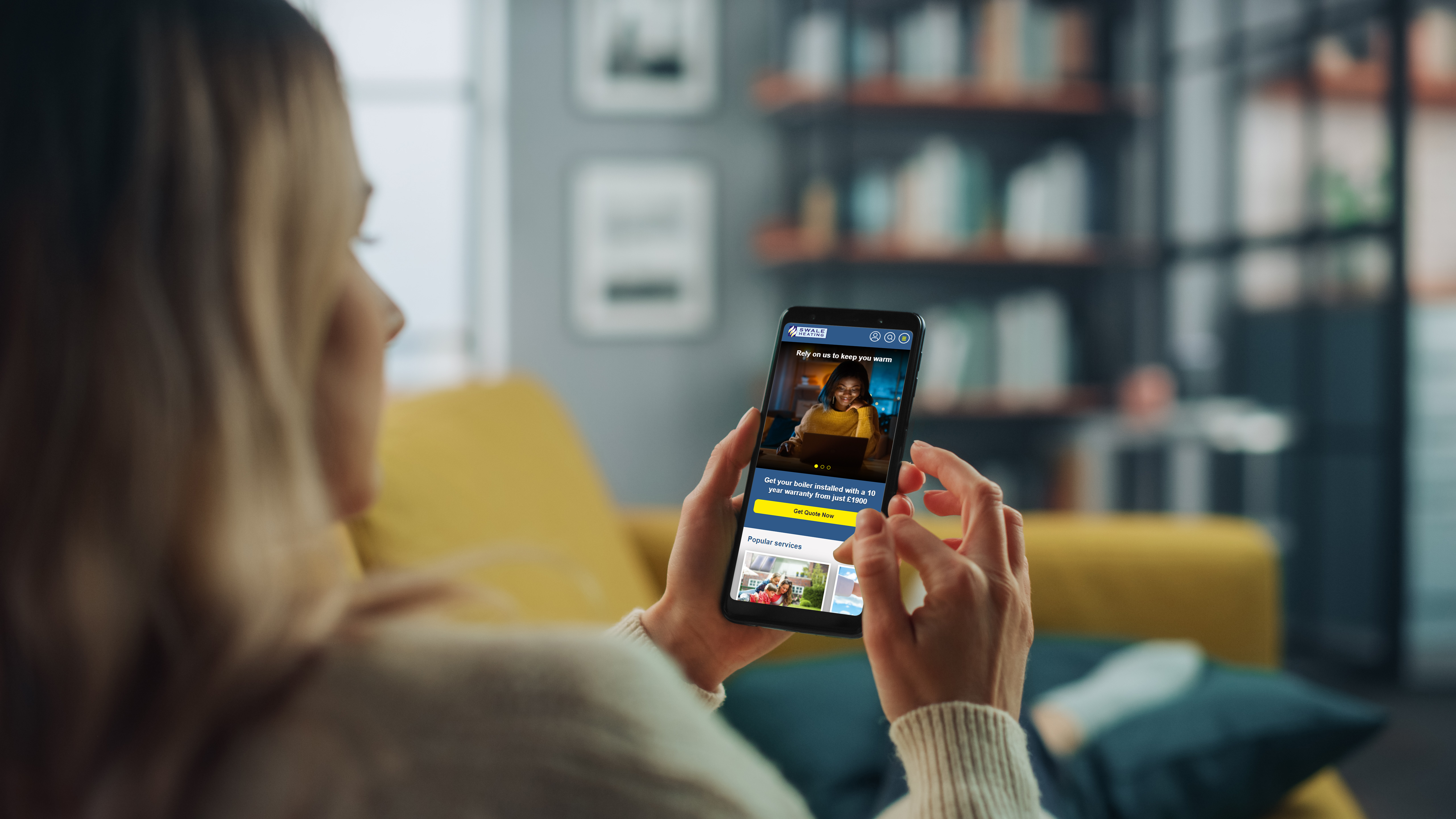 Woman using Swale Heating website on mobile phone